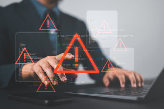 Ransomware malware attack and data breach. Businessperson using laptop with spam virus on warning caution for notification on internet security protect.