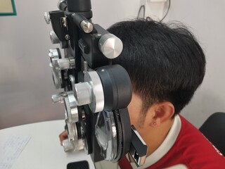man with eye test for glasses set on background