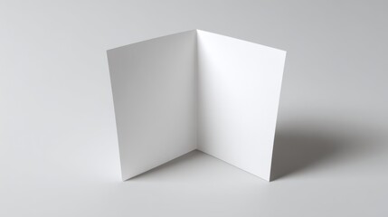 Fototapeta premium An empty, blank white card displayed on a light gray background, ideal for custom designs or messages.