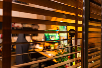 Cozy modern desk setup with warm ambient lighting and green monitor glow, featuring gadgets, keyboard, mic, and gaming chair in a stylish studio workspace. Perfect for background or lifestyle tech the