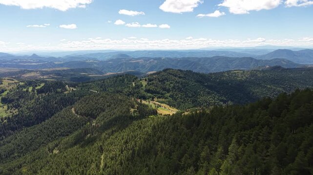 Beautiful Mountain Landscape on Sunny Summer Day. Pine Forest on Hills and Misty Horizon of Zlatibor Mountain, Serbia