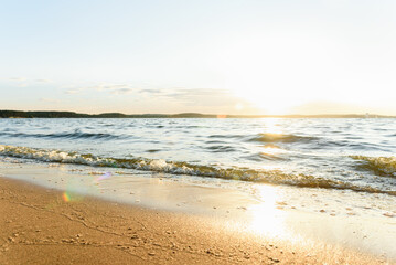 Sandy beautiful beach, calm sea surface and very small waves.