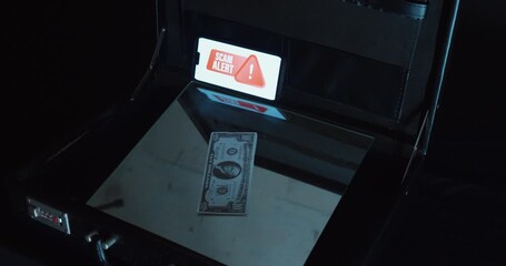 An open briefcase with a dollar bill and a “Scam Alert” warning sign. Symbolic scene for internet fraud, phishing scams, fake companies, and cybersecurity awareness training. - Powered by Adobe