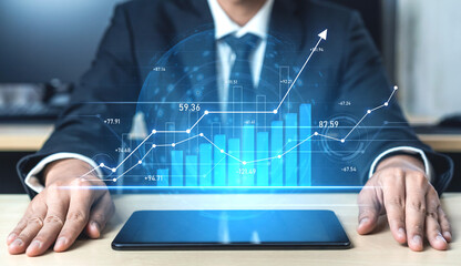A businessman examines digital graphs and charts displayed on a tablet, illustrating financial data and growth metrics in a modern office setting. Scalp