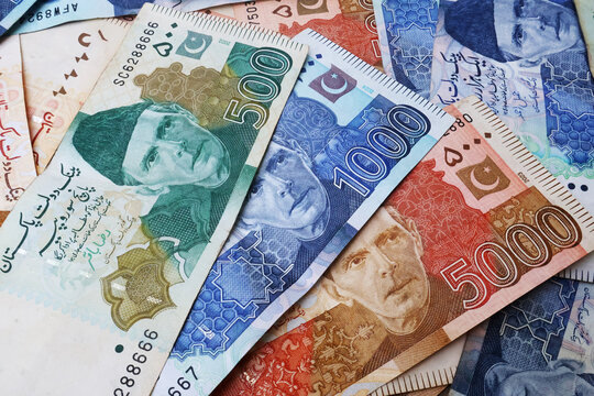 Pakistani paper money of different values placed together, symbolizing finance, economy, savings, and investment in Pakistan. featuring Quaid-e-Azam Muhammad Ali Jinnah portrait and security features.