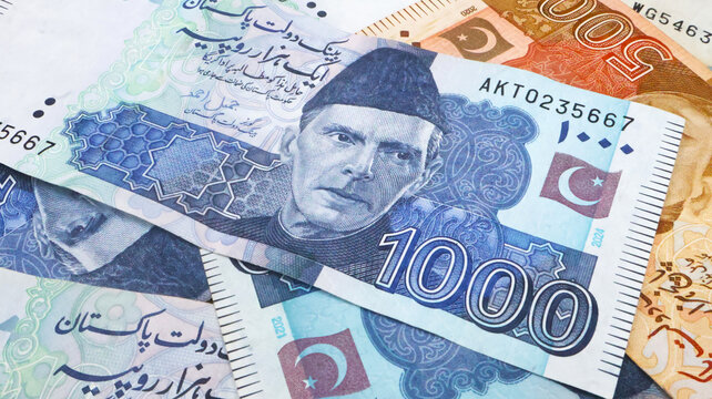 Pakistani paper money of different values placed together, symbolizing finance, economy, savings, and investment in Pakistan. featuring Quaid-e-Azam Muhammad Ali Jinnah portrait and security features.