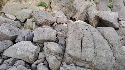 rough textured pile of large natural coastal rocks