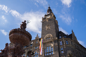 Ornate fountain and historic tower against blue sky horizontal