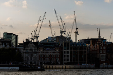 Construction cranes over London city skyline