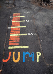 The jump distances scale painted on the school yard