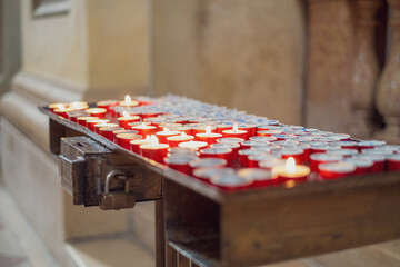 Prayer candles inside a Catholic church.