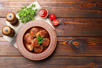 Roasted meat patties served on wooden table, flat lay. Space for text