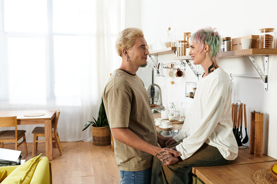 Young couple sharing a moment of love and connection in a cozy kitchen setting