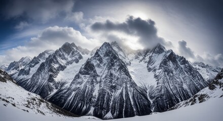 Snow covered mountain peaks under dramatic cloudy sky