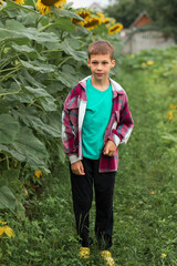 a full-length portrait of a child. Dressed in black sweatpants, a T-shirt, and a shirt