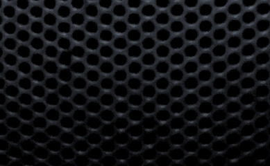 たくさんの黒い色の円の穴があいた模様でデザインした背景、壁紙、テクスチャ