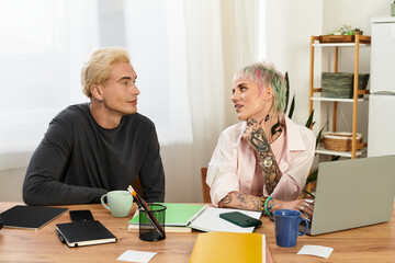 Young couple sharing a joyful moment in a cozy workspace filled with love and creativity