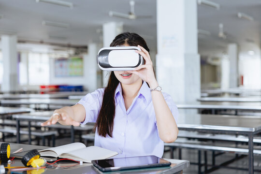 Students teen in uniform learning STEM with VR headset technology at school campus
