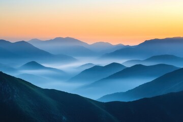 Fototapeta premium Mountain landscape in the fog at sunrise. View from the top of the mountain.