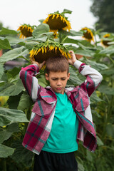 a child with closed eyes holds a sunflower in its hands and tilts it over its head