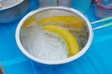 Banana soaking in ice water for freshness at event