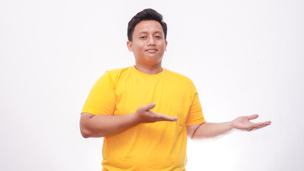 Smiling Asian fat man pointing to the right side on white background