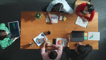 Top down view of manager holds tablet display increasing sales and placed on meeting table. Group of diverse business team clapping hands to celebrate successful product at meeting room Convocation. - Powered by Adobe