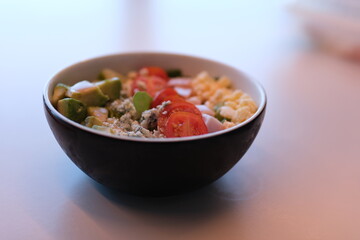 Salad bowl table fresh vegetable salad of tomato, avocado, lettuce and spinach. Healthy and detox food concept. Ketogenic diet. Buddha bowl dish on white background, top view. Banner.