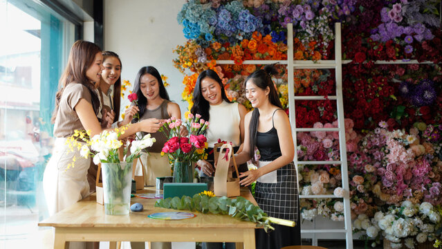 A group of women are working on a floral arrangement in flower shop. women are working together to create a beautiful display