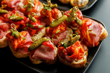 Close-up of gourmet meat canapes with pickles and peppers