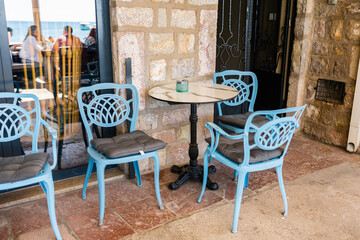 Blue patio chairs with cushions in sunny veranda. Outdoor elegance, Mediterranean leisure, and summer hospitality design.