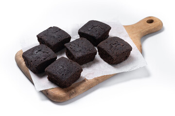 Homemade chocolate brownies on cutting board isolated on white background