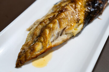 roasted mackerel on a white ceramic dish