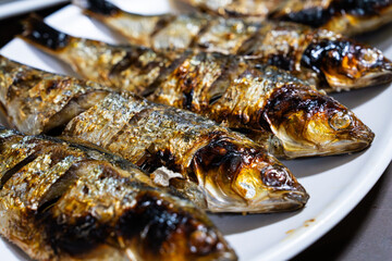 roasted gizzard shads on a white dish