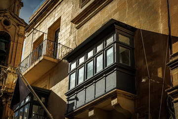Fototapeta premium Traditional black balcony on Maltese limestone building