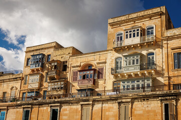 Old waterfront buildings with wooden balconies in Valletta