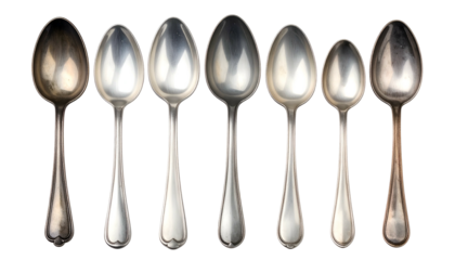 Elegant Silver Spoons Arrayed in a Row Displaying Various Designs and Sizes.