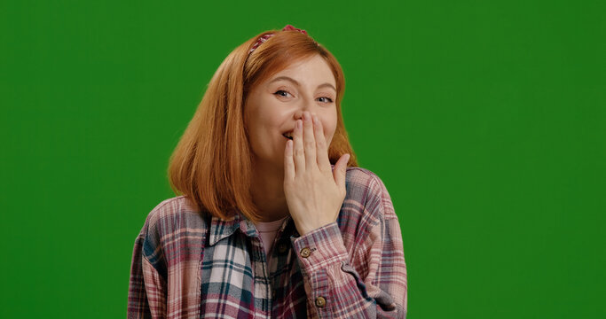 Secret woman in a studio with a finger on her mouth for gossip or silence. Whisper, noise and portrait a quiet hand gesture by a green screen background. Put hand to mouth to tell a secret - Powered by Adobe
