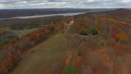 Aerial view of Staatsburgh State Historic Site nestled among colorful autumn trees overlooking the Hudson River, Hudson, New York, United States.