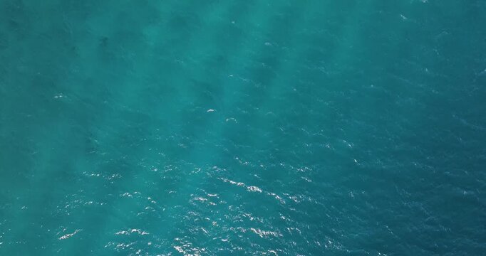 Aerial view of the turquoise sea water with subtle waves creating patterns and textures, a stunning display of nature's beauty, Erchie, Amalfi Coast, Italy.