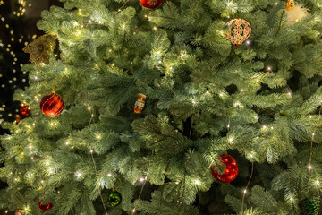 Close-up of a beautifully decorated Christmas tree with sparkling lights and colorful ornaments, radiating warmth and holiday cheer.
