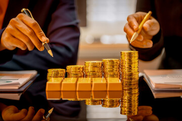 A suited Asian analyst confirms the tangible value of global gold holdings, carefully placing a...