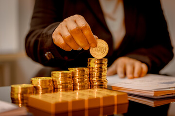 A suited Asian analyst confirms the tangible value of global gold holdings, carefully placing a...