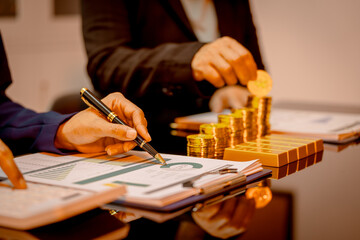 A suited Asian analyst confirms the tangible value of global gold holdings, carefully placing a...