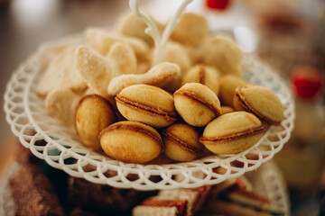 Homemade cookies shaped like walnuts with caramel filling, served on a decorative stand. A traditional Ukrainian dessert that adds warmth and sweetness to the festive table.