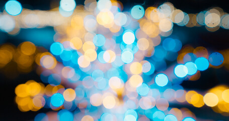 Christmas defocused ice skating rink bokeh background. Shimmering abstract warm circles defocused....