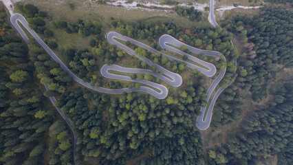 hairpin serpentine mountain forest road. asphalt road. Stelviopass Italy.