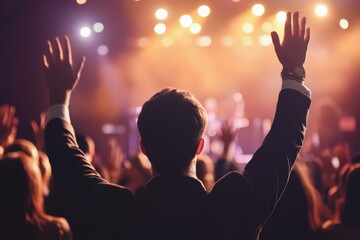 Ecstatic Concert Audience with Hands Raised Silhouetted by Stage Lighting, Feeling the Rhythm and Musical Energy