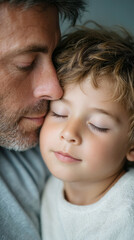 Tender moment: father kissing son's forehead at bedtime