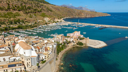 Obraz premium Aerial view of the historic centre of Castellammare del Golfo, a town located in the province of Trapani, Sicily, Italy. In the background is the tourist port overlooking the Mediterranean Sea.